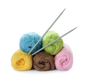 Soft woolen yarns and knitting needles on white background