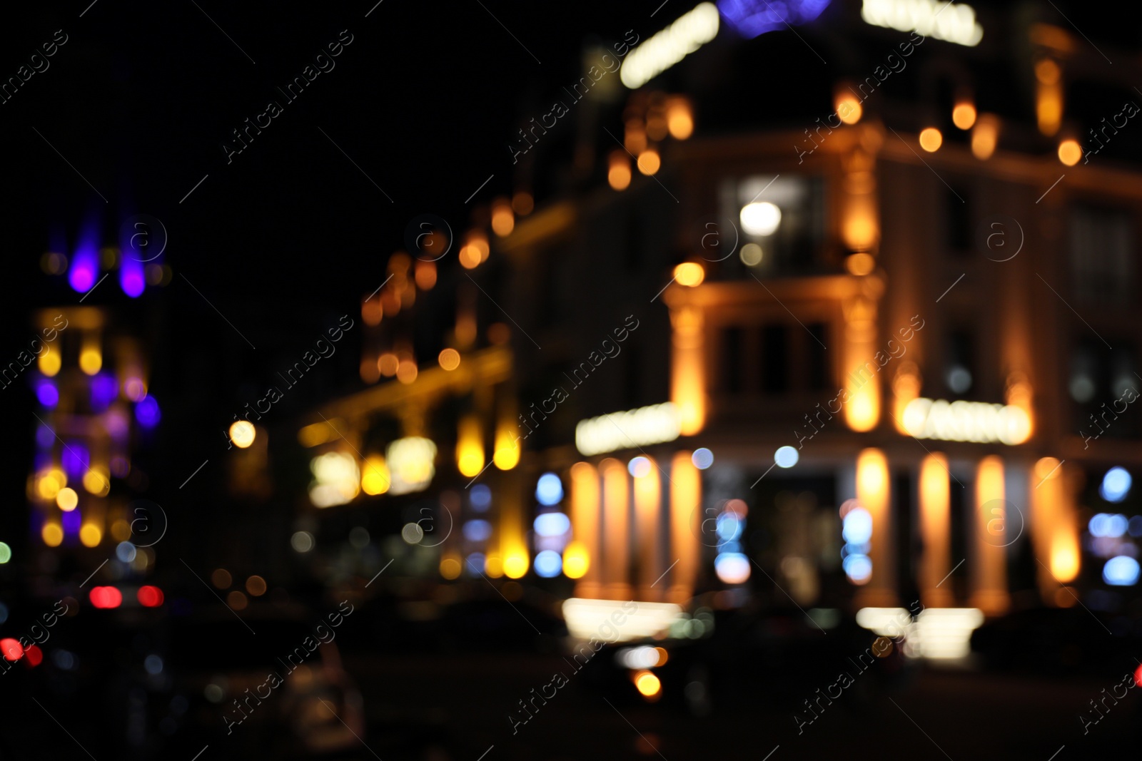 Photo of Blurred view of city street with lights at night. Bokeh effect