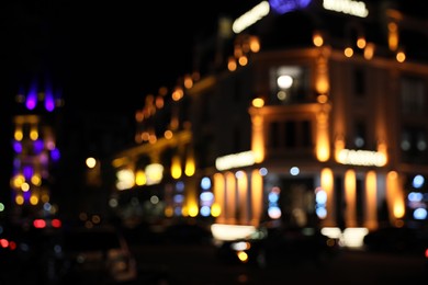 Blurred view of city street with lights at night. Bokeh effect