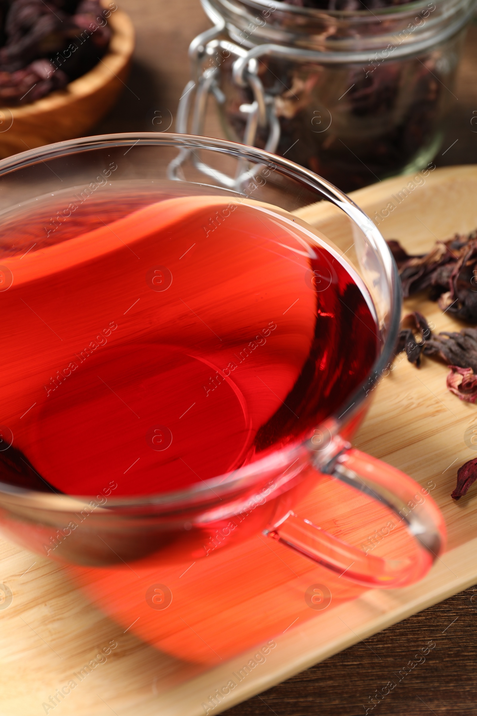 Photo of Cup of fresh hibiscus tea on table, closeup