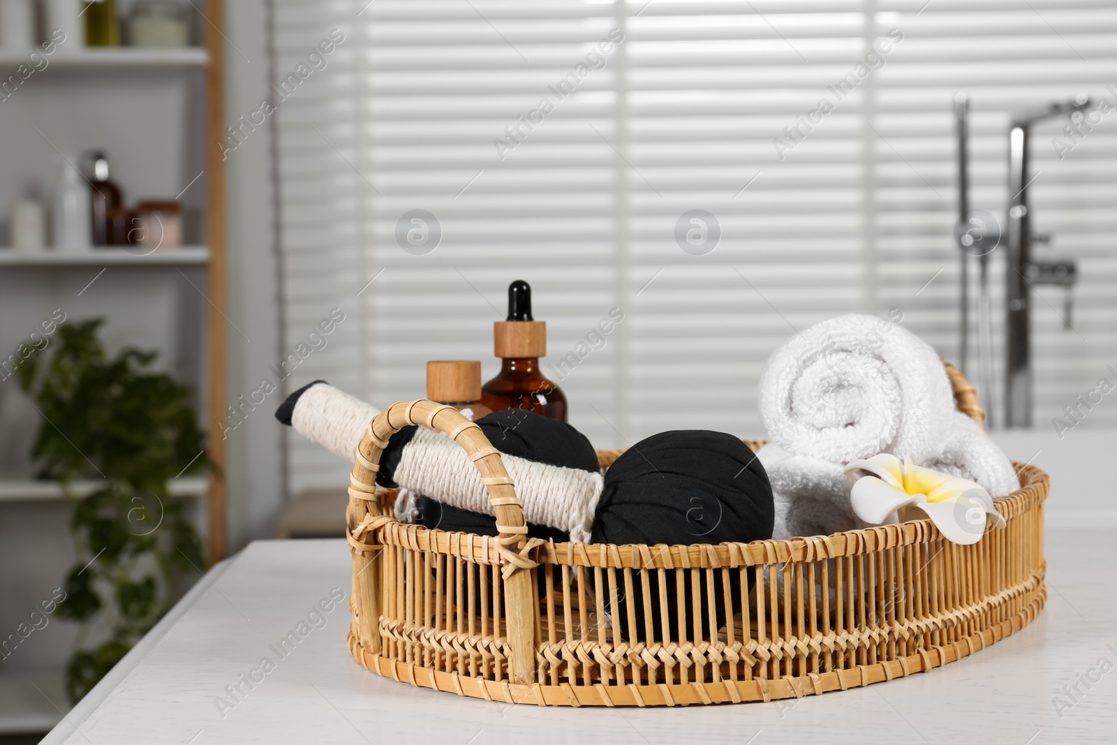 Photo of Beautiful composition with different spa products and flower on white wooden table in bathroom, space for text