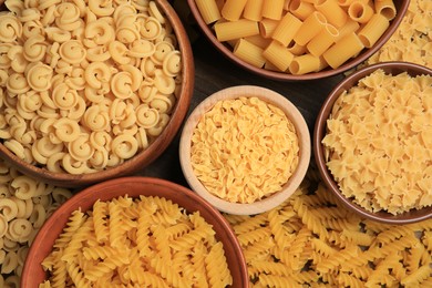 Different types of pasta on table, flat lay