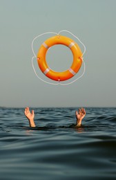 Image of Drowning man with raised hands getting lifebelt in sea