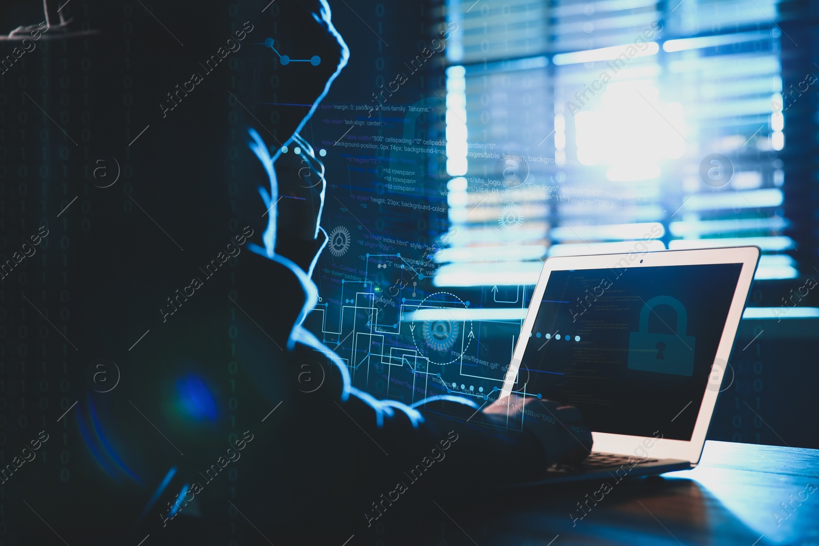 Image of Hacker working with laptop at table indoors. Cyber attack