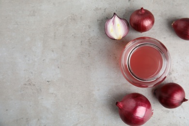 Photo of Flat lay composition with onion syrup in jar and space for text on table