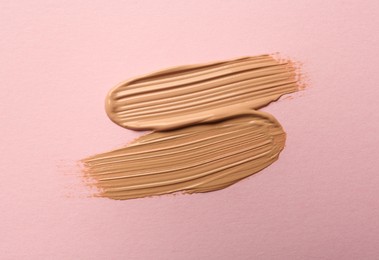 Photo of Sample of liquid skin foundation on pink background, top view