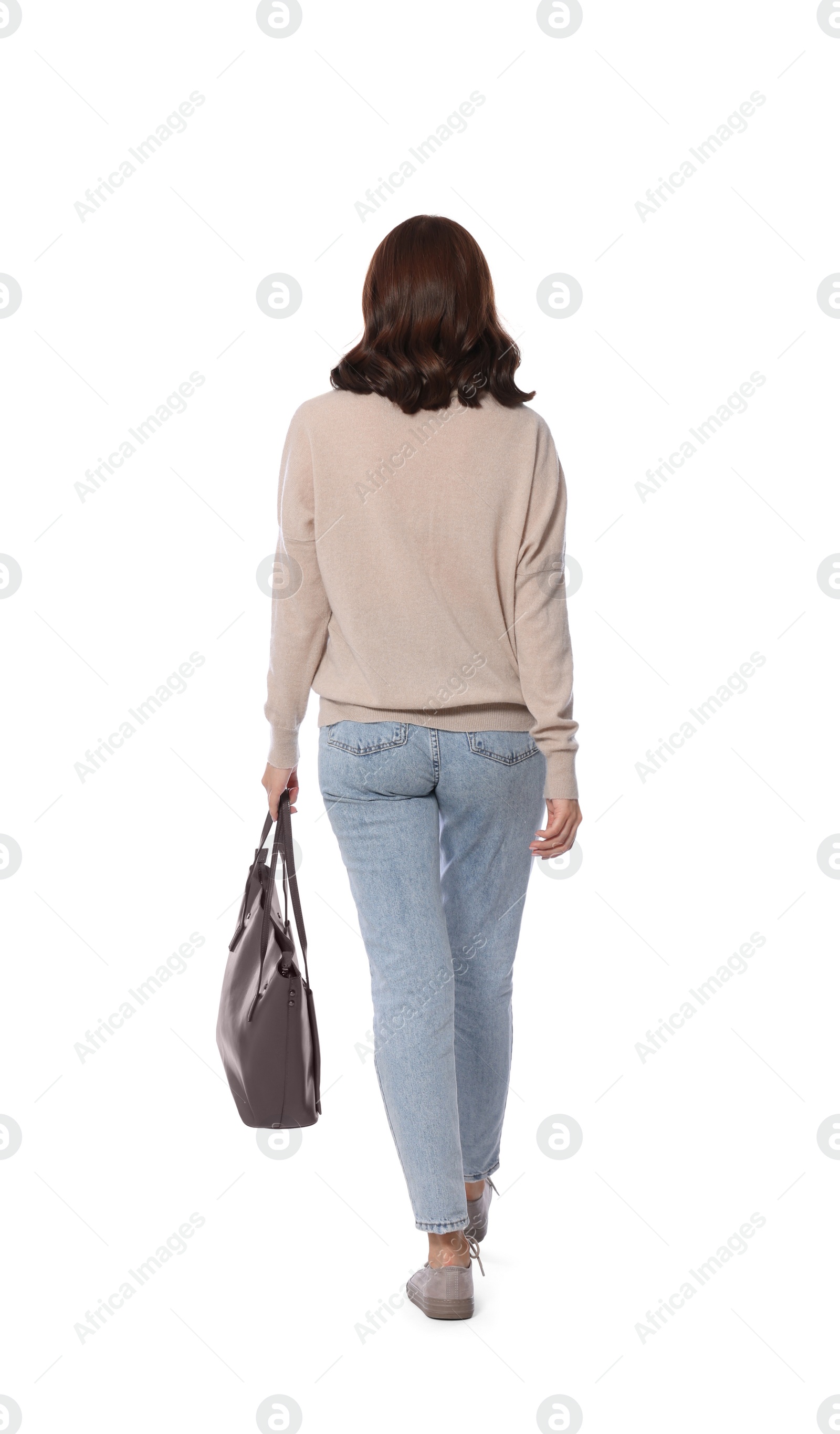 Photo of Woman with stylish bag walking on white background, back view