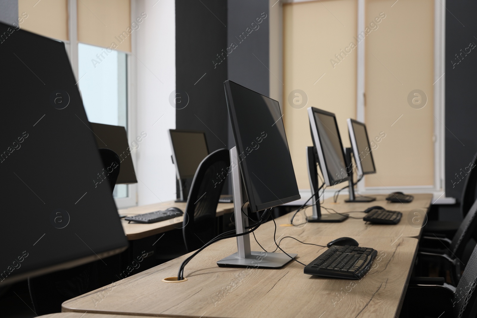 Photo of Many modern computers in open space office