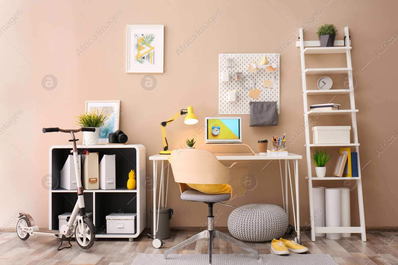 Photo of Modern laptop on desk in room. Home workplace