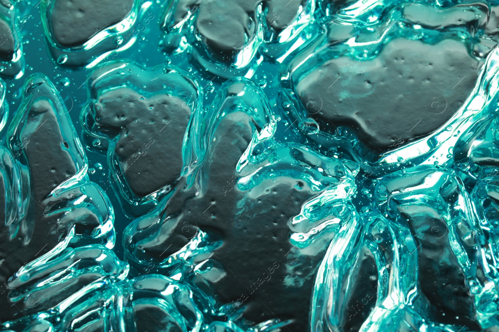 Photo of Beautiful blue gel on silver background, closeup