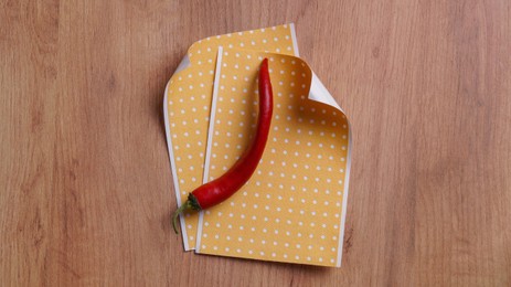 Pepper plasters and chili on wooden table, flat lay