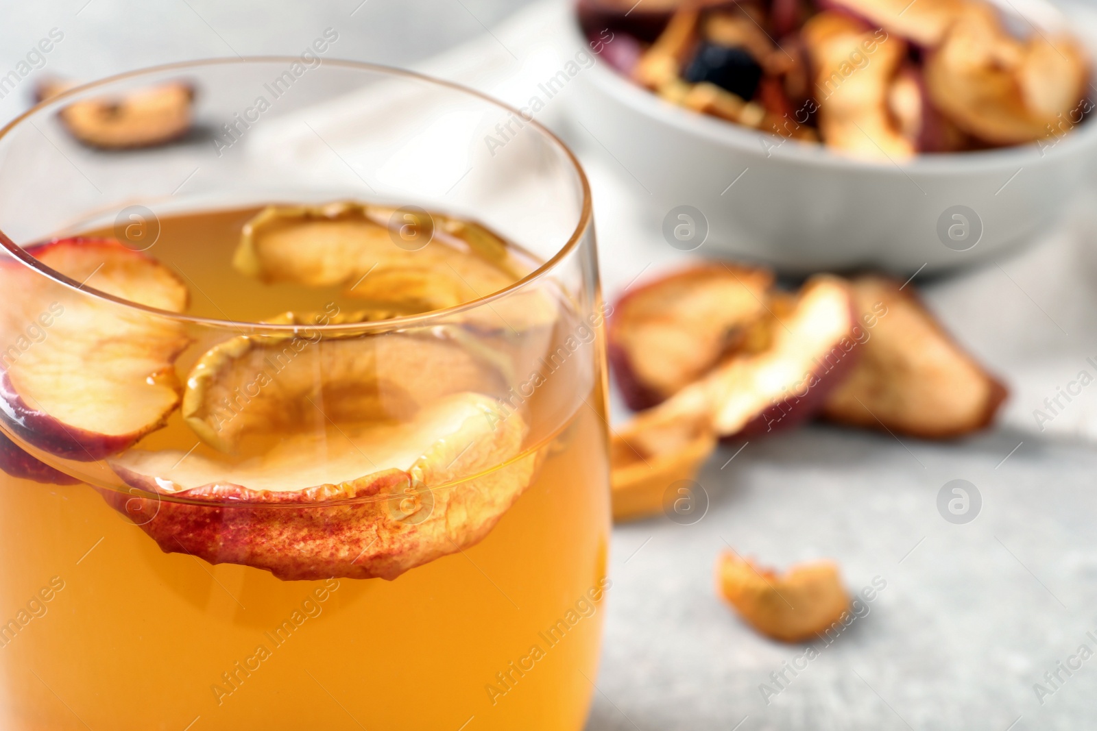 Photo of Delicious compote with dried apple slices in glass, closeup. Space for text