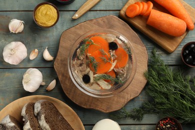 Delicious aspic and ingredients served on light blue wooden table, flat lay