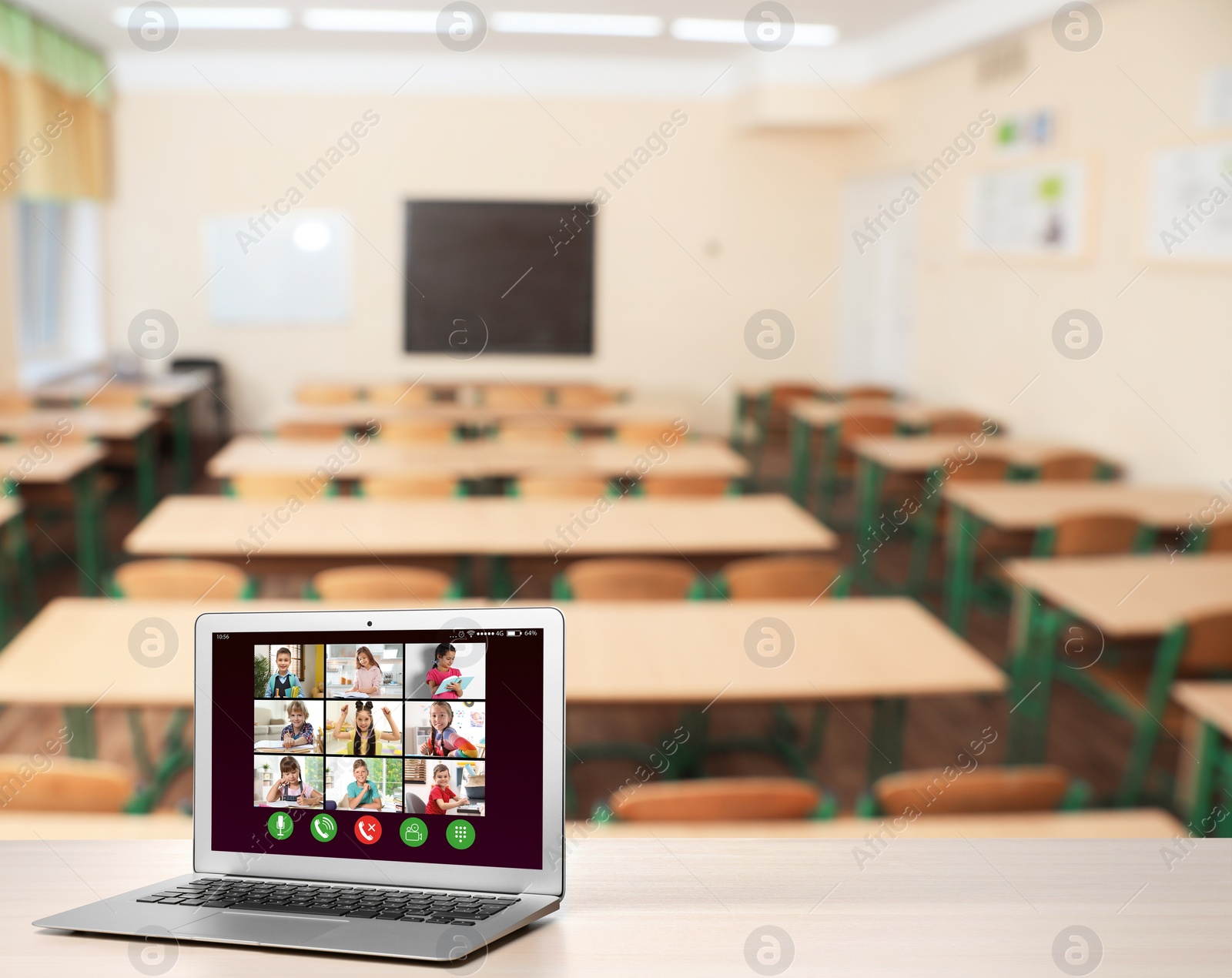 Image of Distance education during quarantine and lockdown due to Covid-19 pandemic. Modern laptop displaying online school lesson in classroom