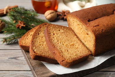 Fresh sliced gingerbread cake on wooden table, closeup