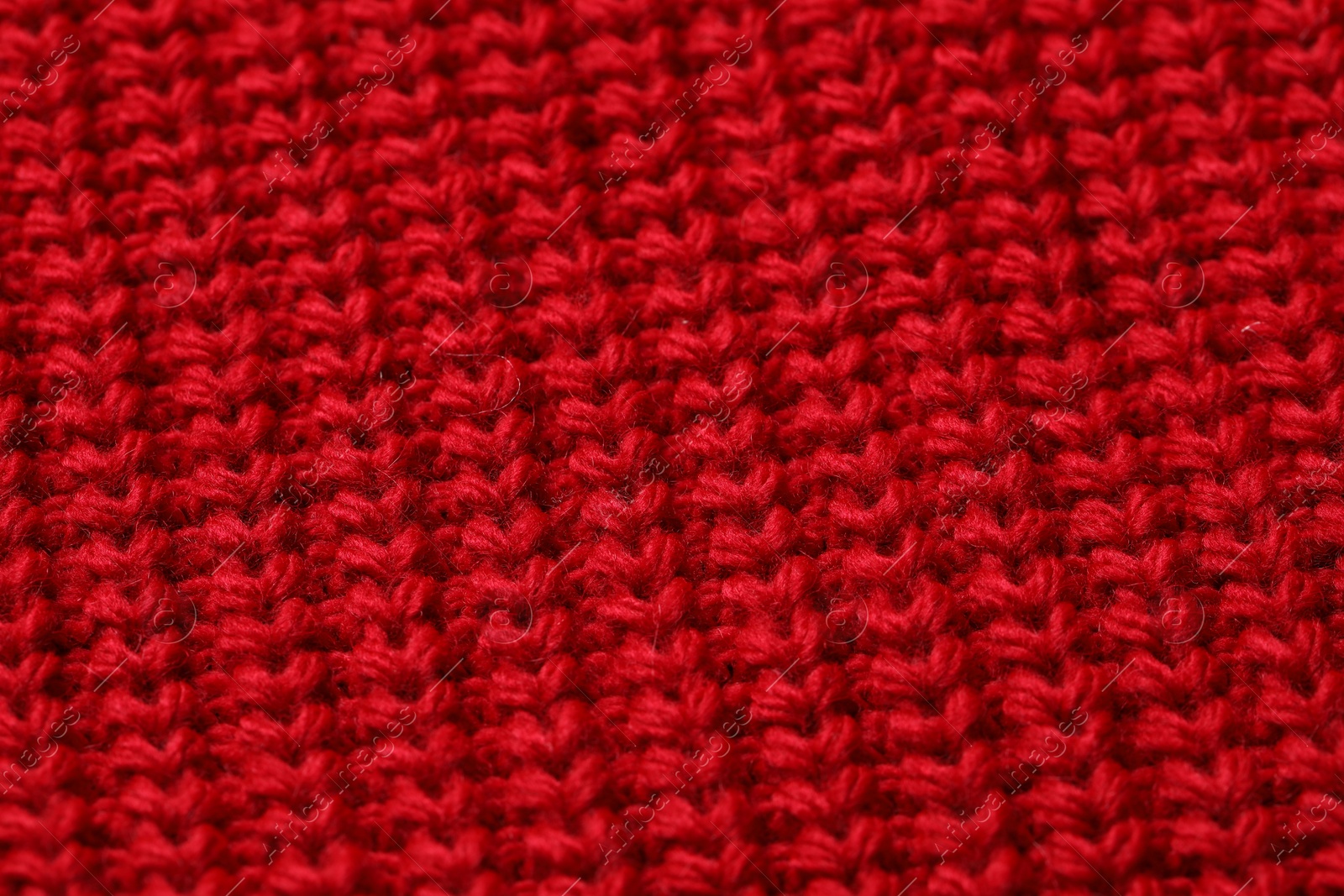 Photo of Texture of soft red knitted fabric as background, top view