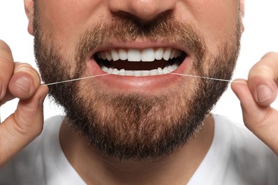 Photo of Man flossing his teeth on white background, closeup. Dental care