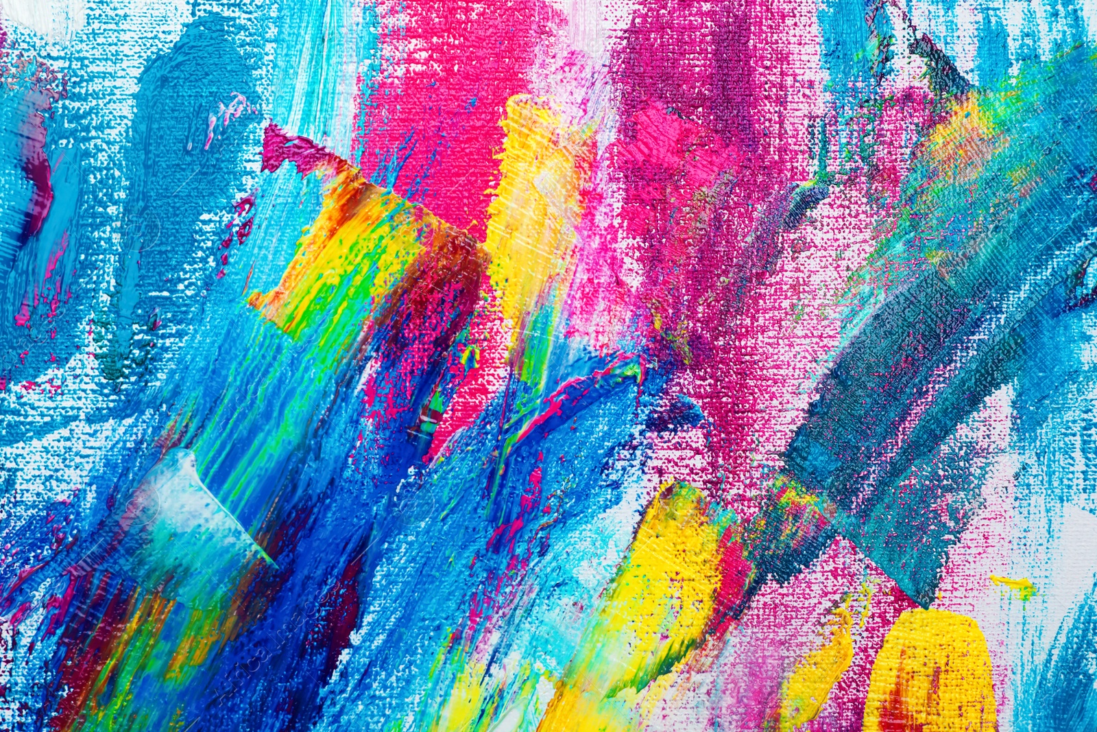 Photo of Strokes of colorful acrylic paints on canvas, closeup