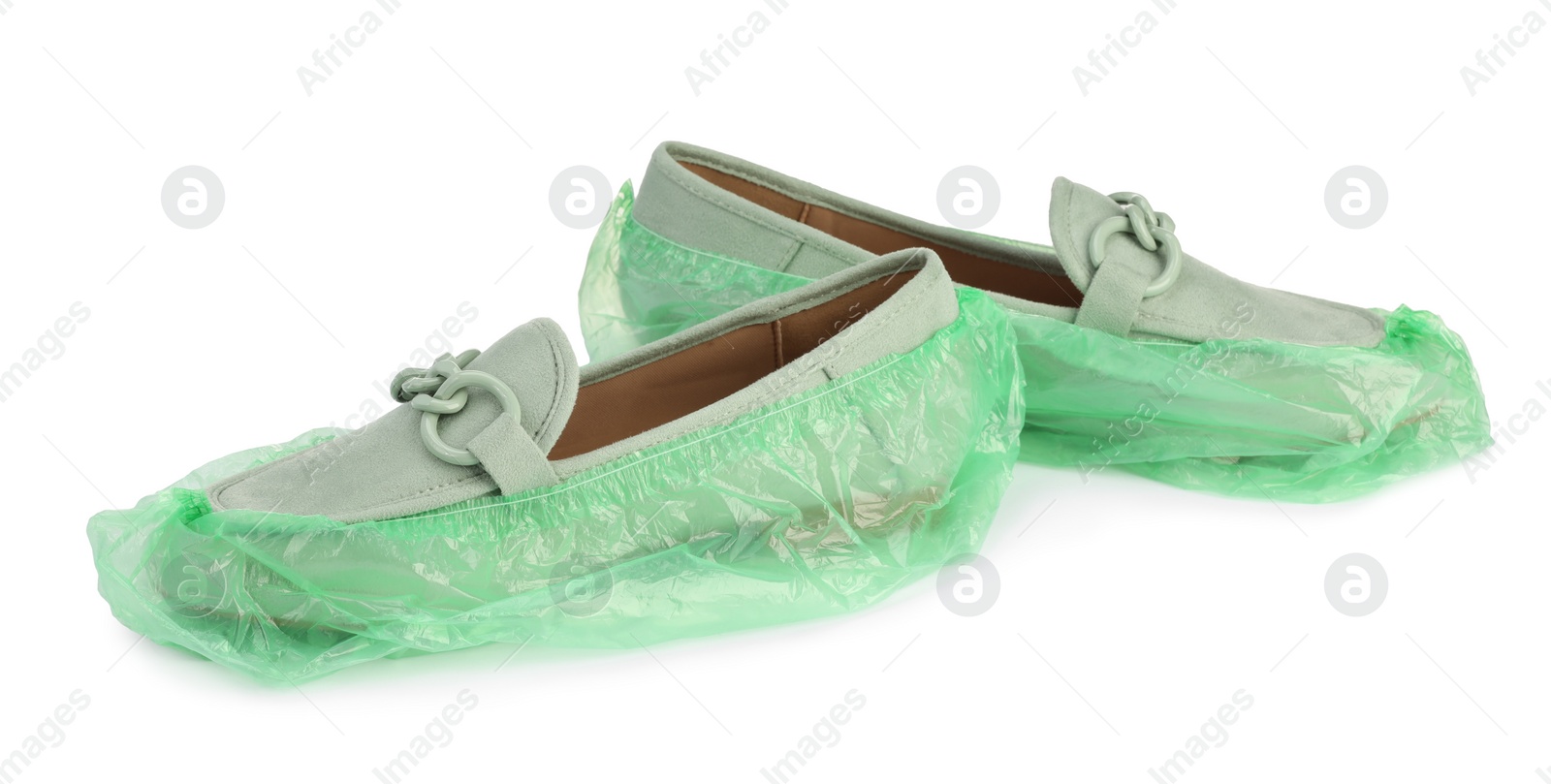 Photo of Women's mules in green shoe covers isolated on white