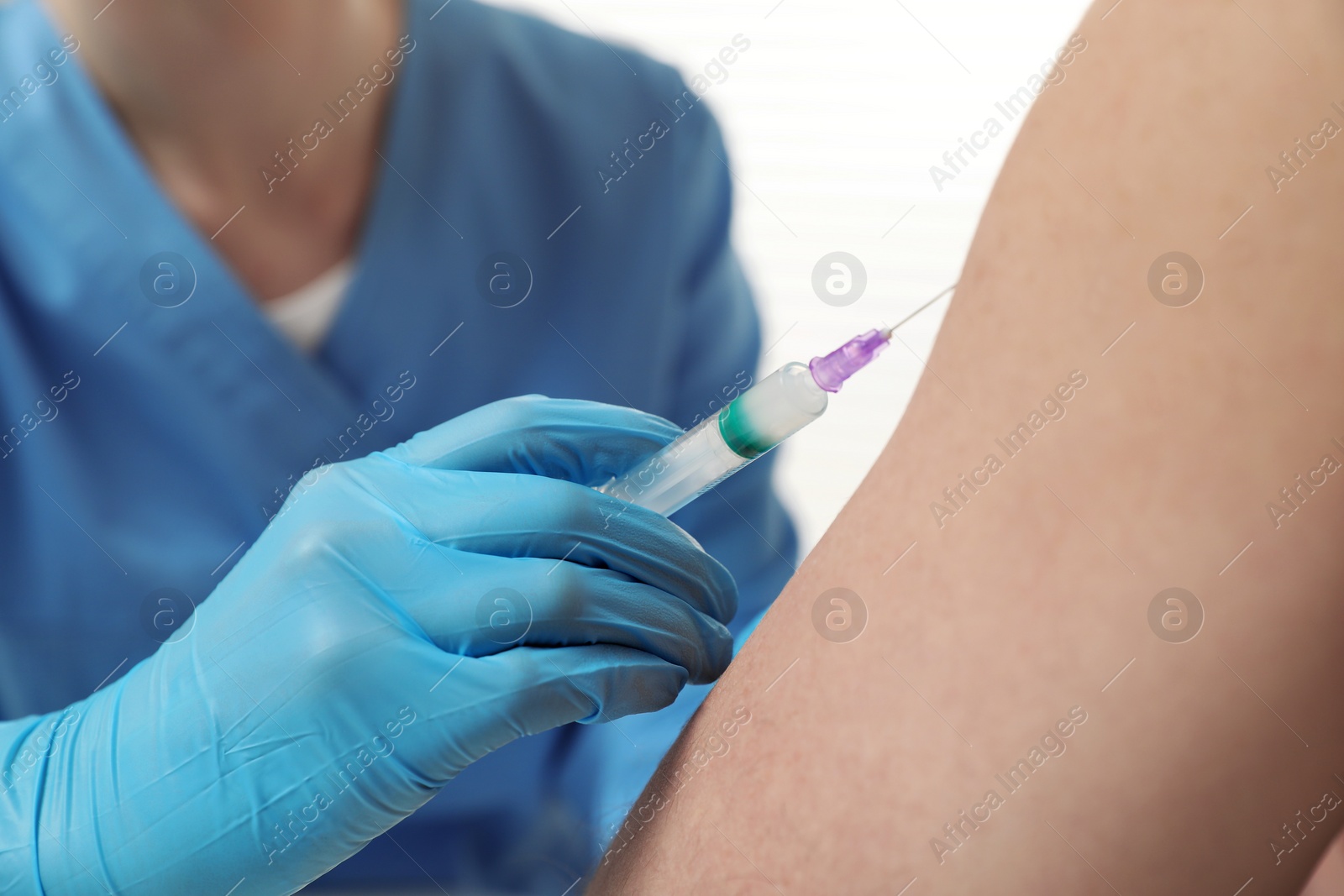 Photo of Doctor giving hepatitis vaccine to patient on white background, closeup