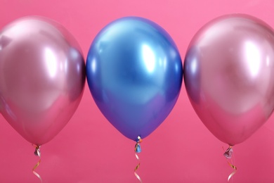 Bright balloons with ribbons on color background