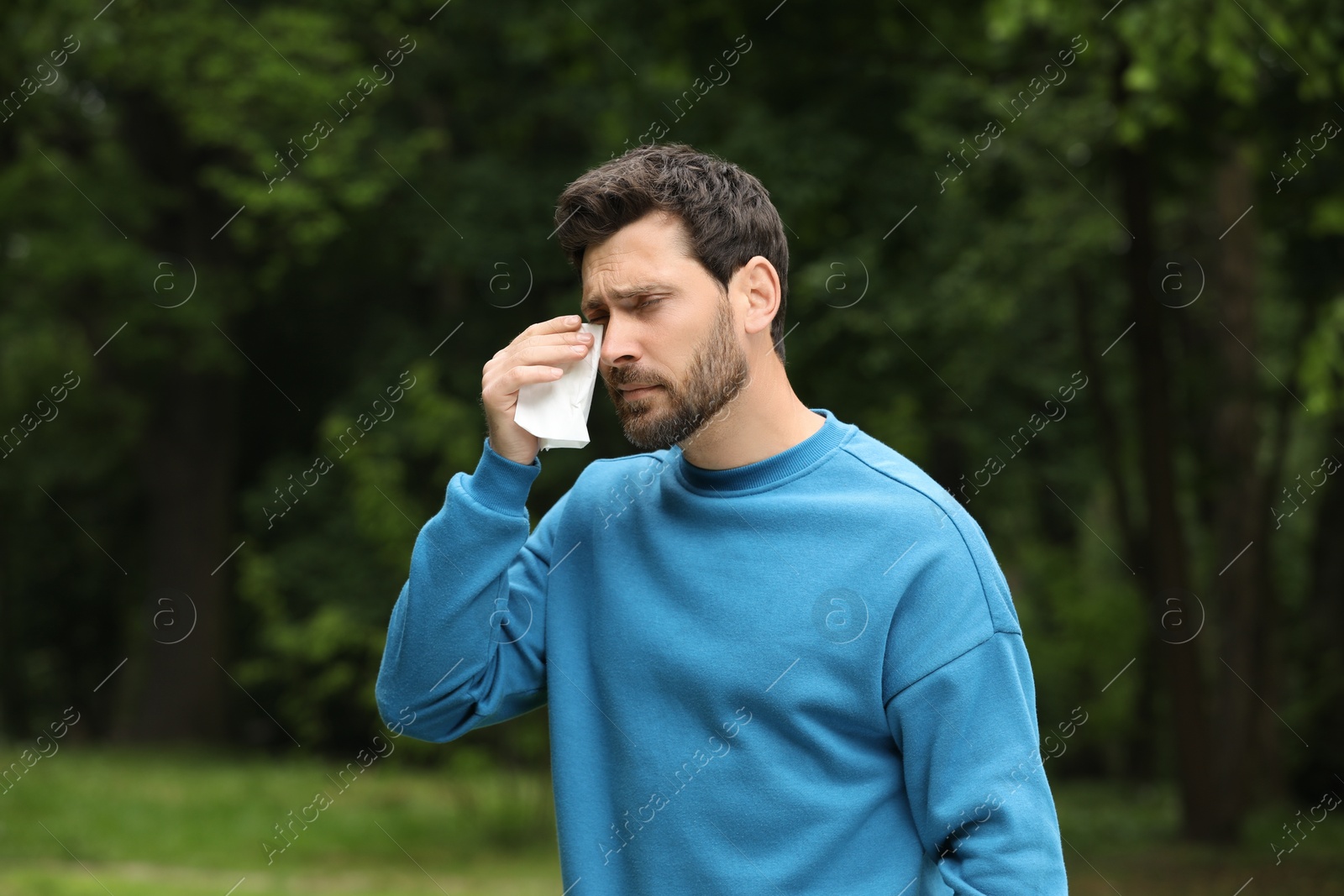 Photo of Man suffering from seasonal spring allergy outdoors