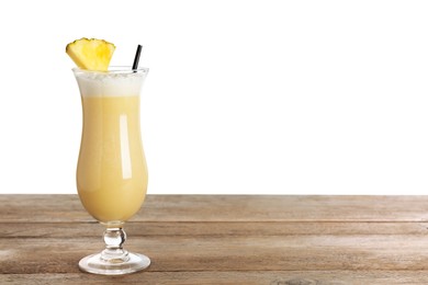 Photo of Tasty Pina Colada cocktail on wooden table against white background, space for text