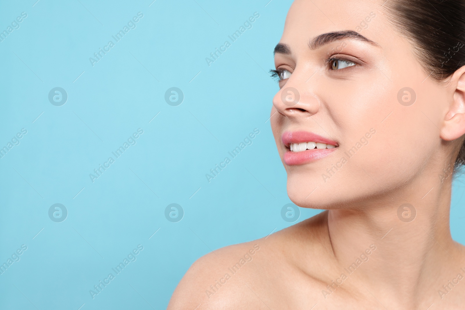 Photo of Portrait of young woman with beautiful face and natural makeup on color background, closeup. Space for text