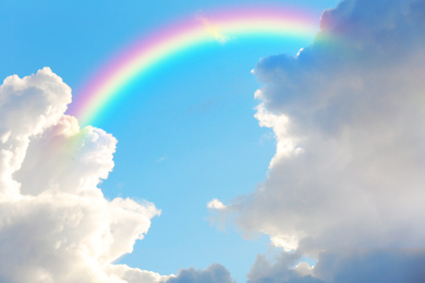 Image of Picturesque view of beautiful rainbow and blue sky on sunny day 