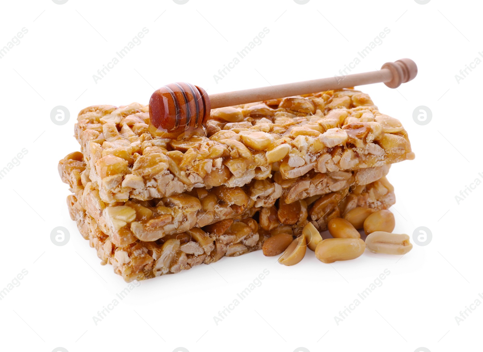 Photo of Tasty kozinaki bars, peanuts and dipper with honey isolated on white