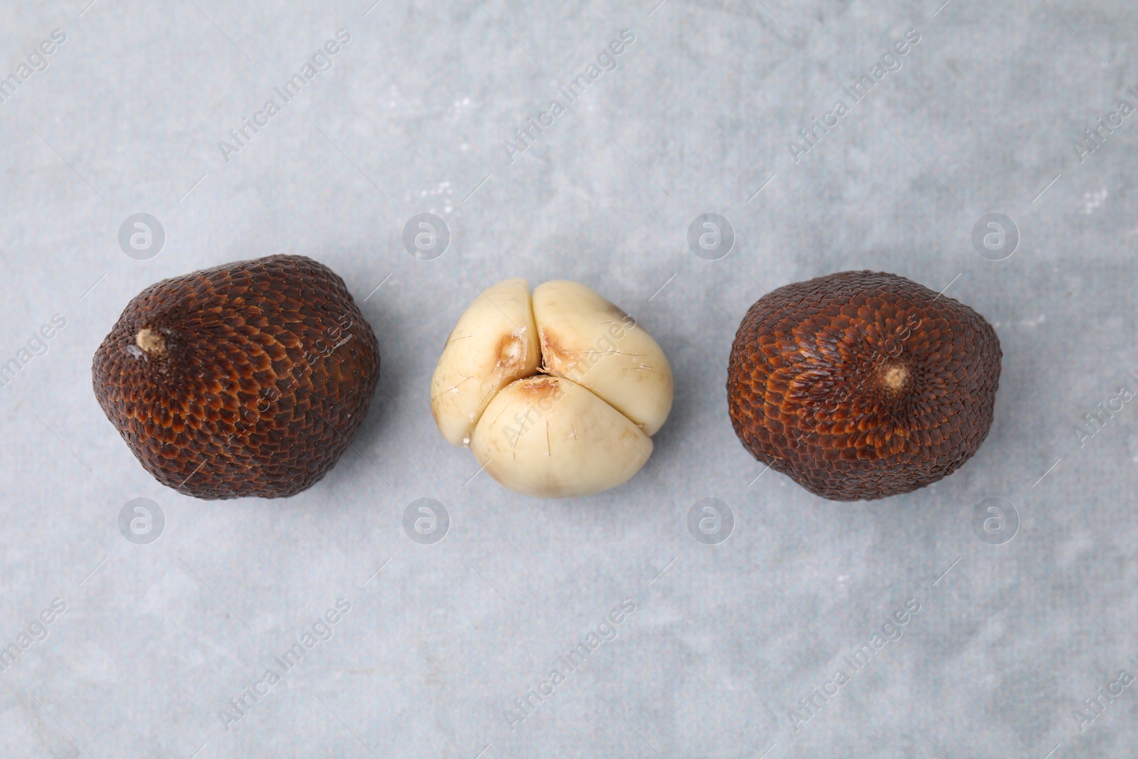 Photo of Fresh salak fruits on light grey table, flat lay