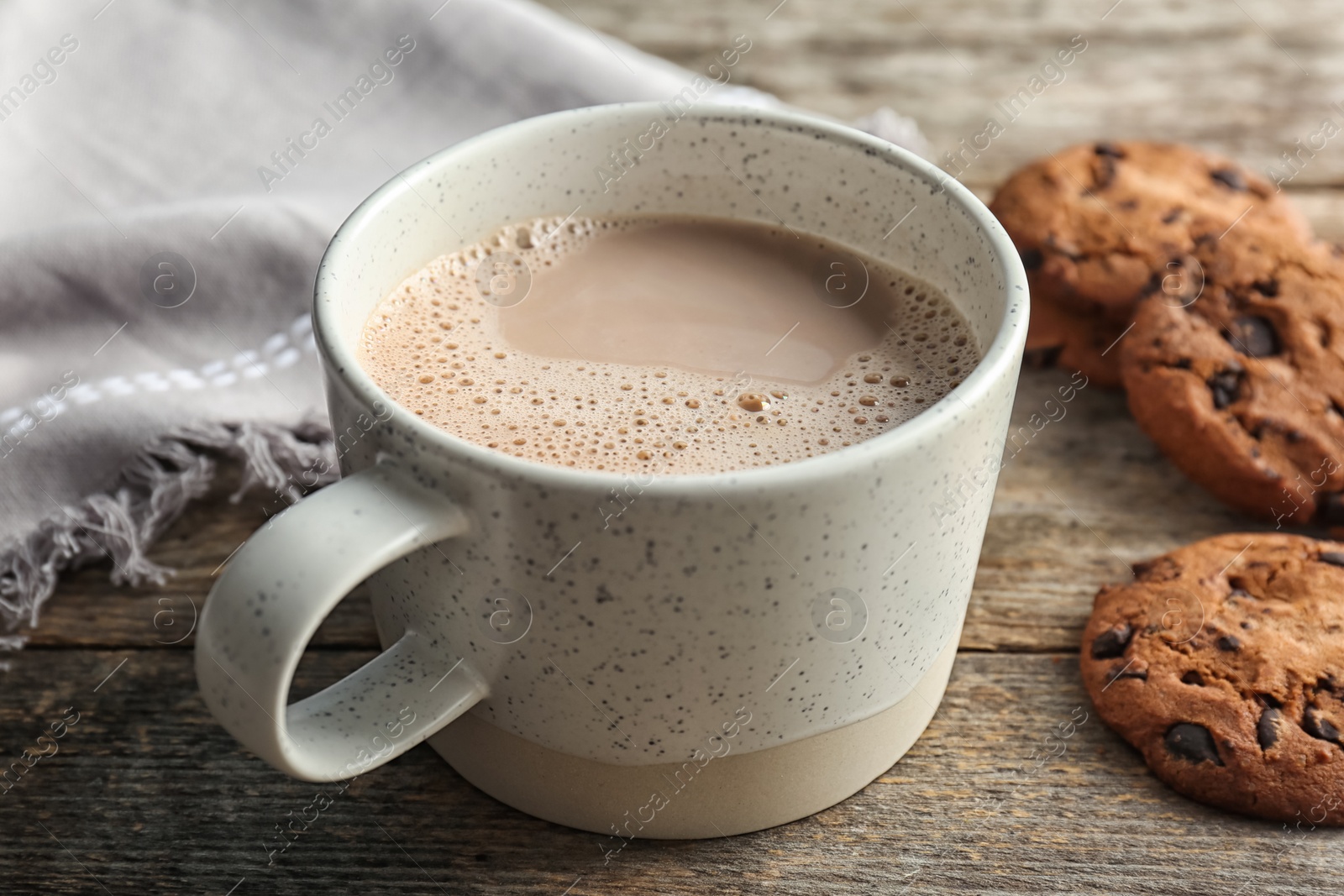 Photo of Cup with delicious hot cocoa drink and cookies on wooden table