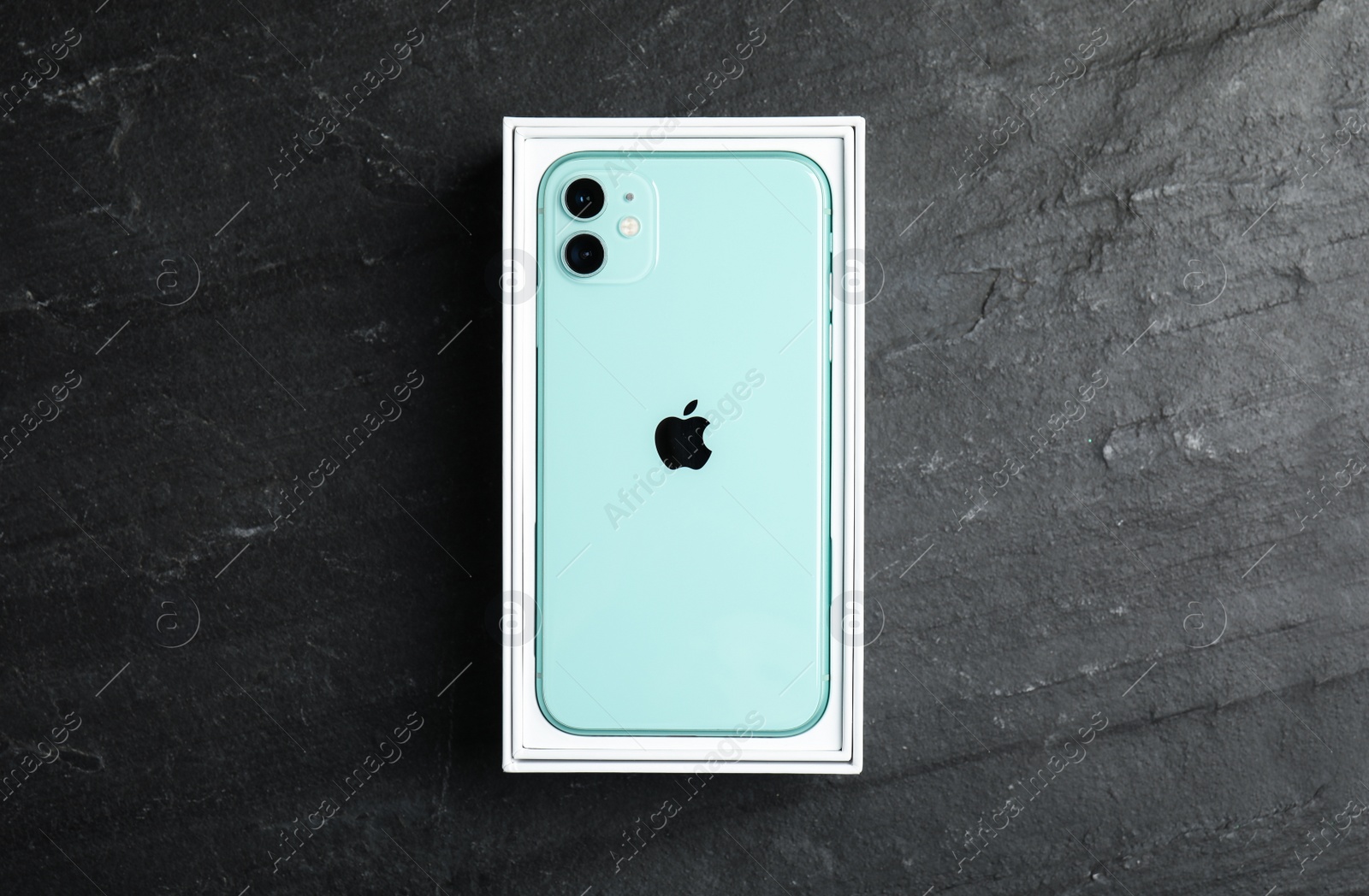 Photo of MYKOLAIV, UKRAINE - JULY 10, 2020: New modern Iphone 11 Green in original box on grey table, top view