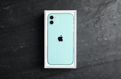 Photo of MYKOLAIV, UKRAINE - JULY 10, 2020: New modern Iphone 11 Green in original box on grey table, top view
