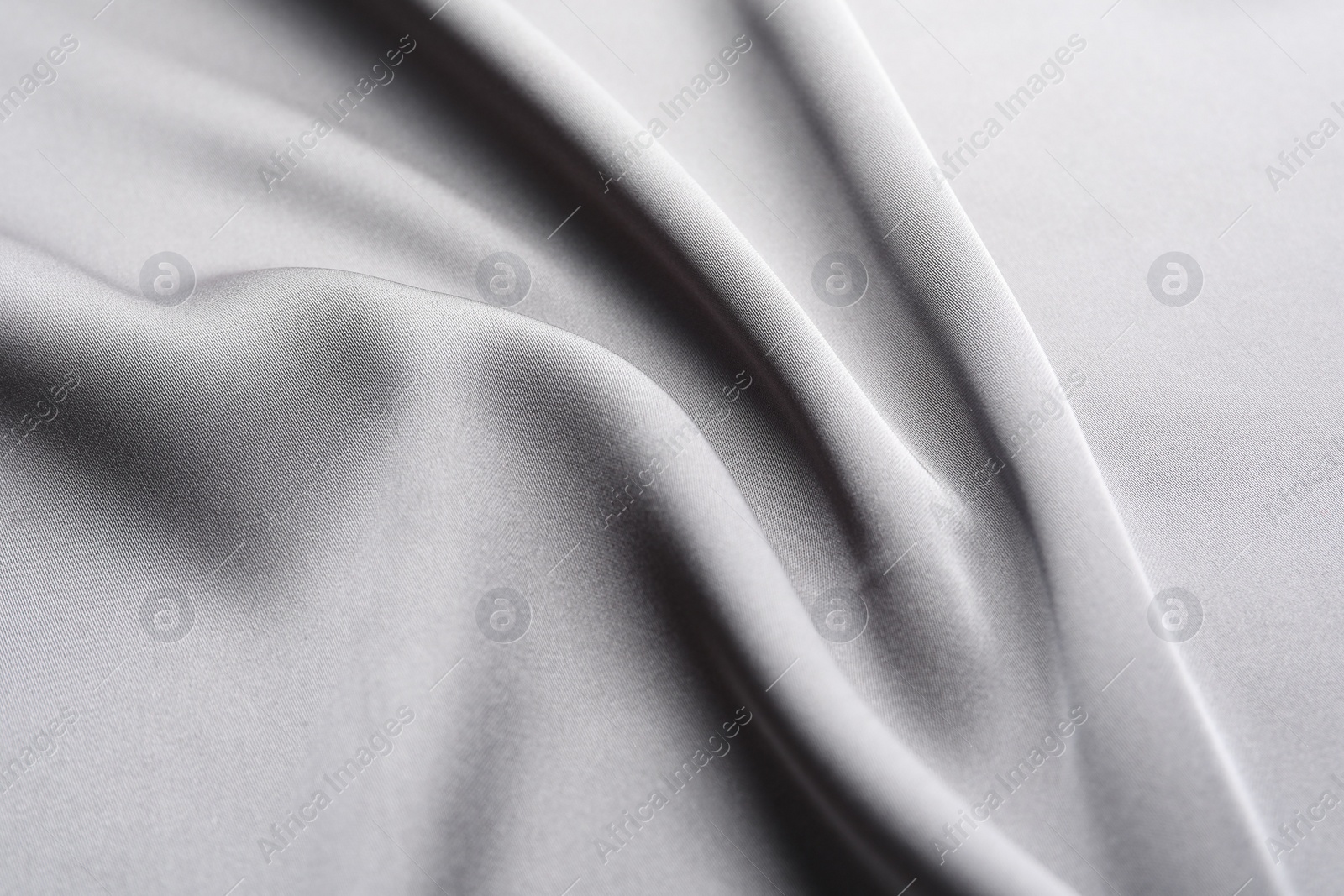 Photo of Texture of beautiful light grey silk fabric as background, closeup