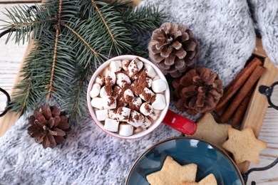 Photo of Cup of tasty cocoa with marshmallows and cookies on tray, flat lay