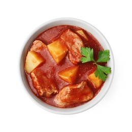 Delicious goulash in bowl isolated on white, top view
