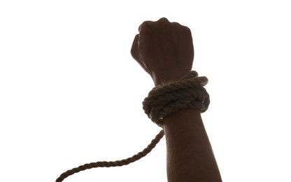 Photo of Freedom concept. Man with tied rope on his hand against white background, closeup