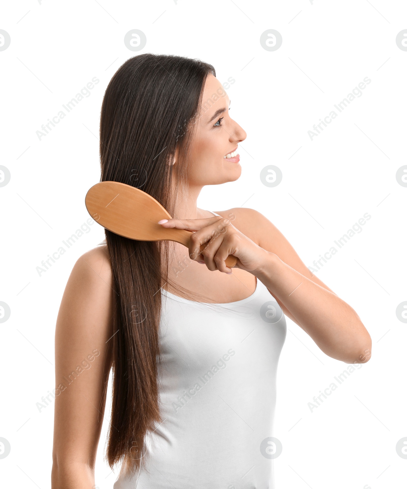 Photo of Beautiful smiling young woman with hair brush on white background