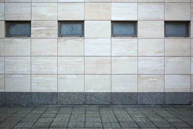 Photo of View on urban tiled wall and pavement