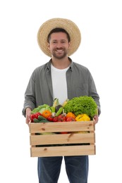 Photo of Harvesting season. Happy farmer holding wooden crate with vegetables on white background