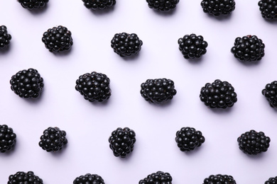 Tasty ripe blackberries on white background, flat lay