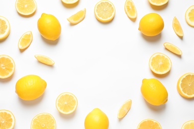 Photo of Frame made of lemons on white background, top view with space for text. Citrus fruits