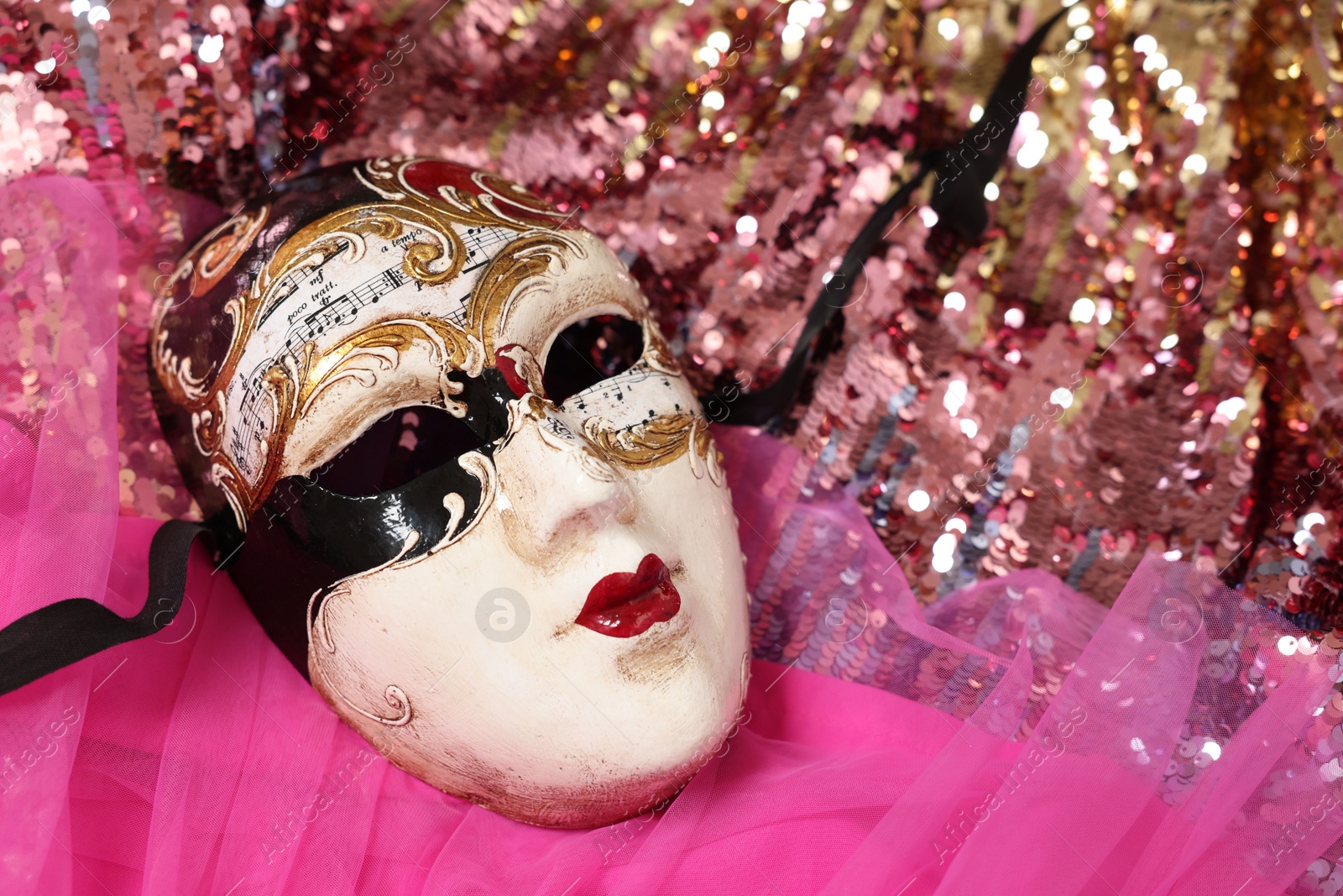 Photo of Carnival mask and beautiful pink costume with sequins, above view