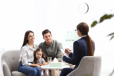 Photo of Professional psychologist working with family in office