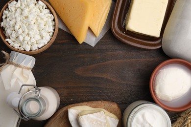 Photo of Frame of different fresh dairy products on wooden table, flat lay. Space for text