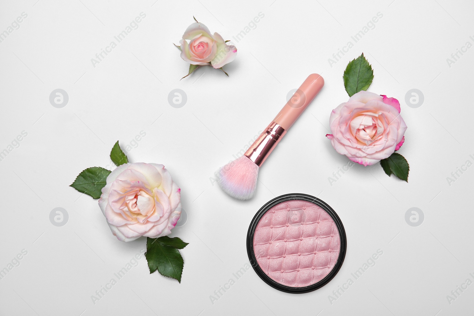 Photo of Flat lay composition with makeup brush, powder and flowers on white background