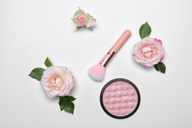 Photo of Flat lay composition with makeup brush, powder and flowers on white background