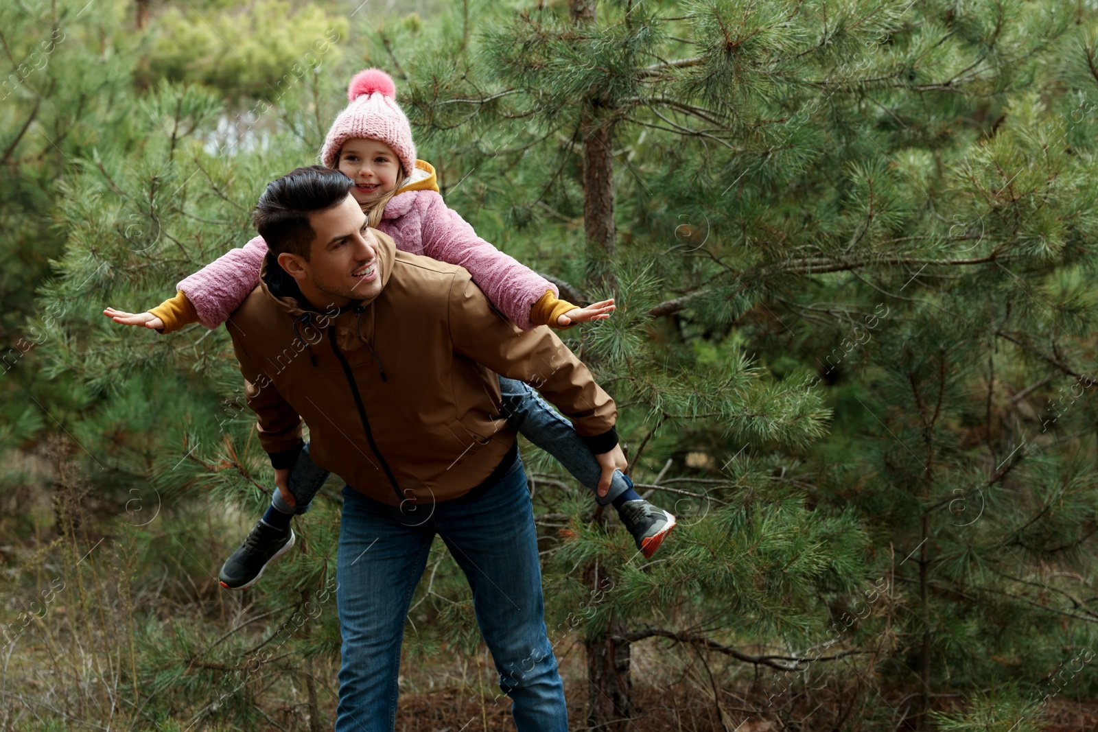 Photo of Man and his daughter spending time together in forest