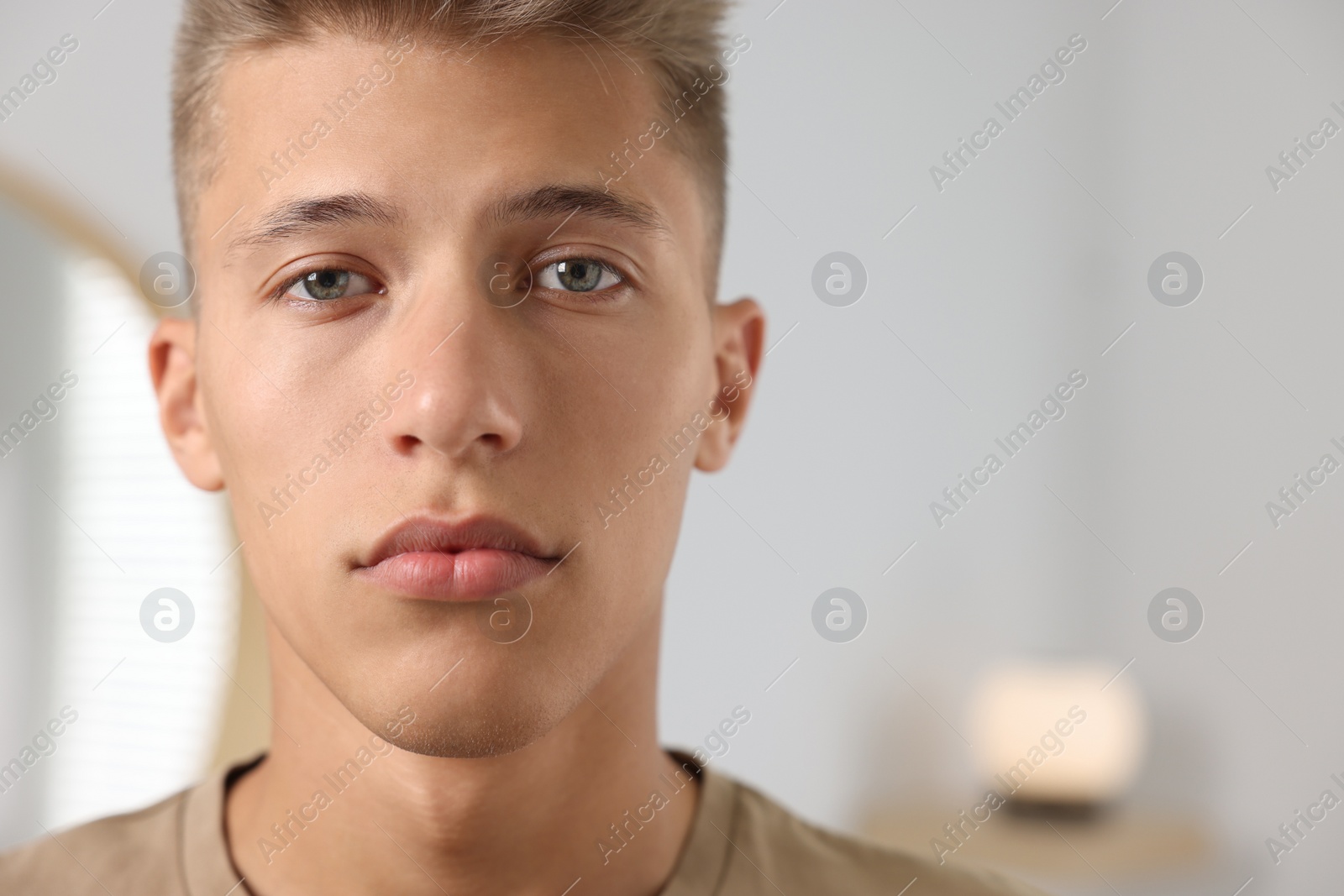 Photo of Portrait of handsome young man indoors, space for text